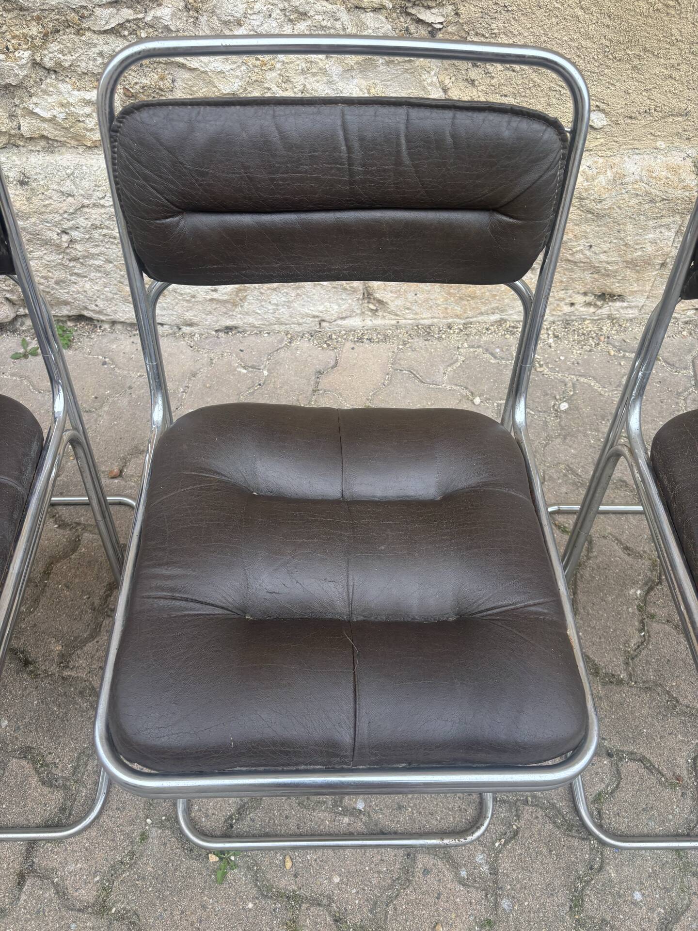Four vintage chairs from the 1960s and 1970s, chrome with faux leather.