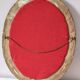 Antique medallion mirror with a gilded and relief-carved frame.