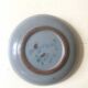 Glazed blue ceramic bowl with stylised fish decoration.