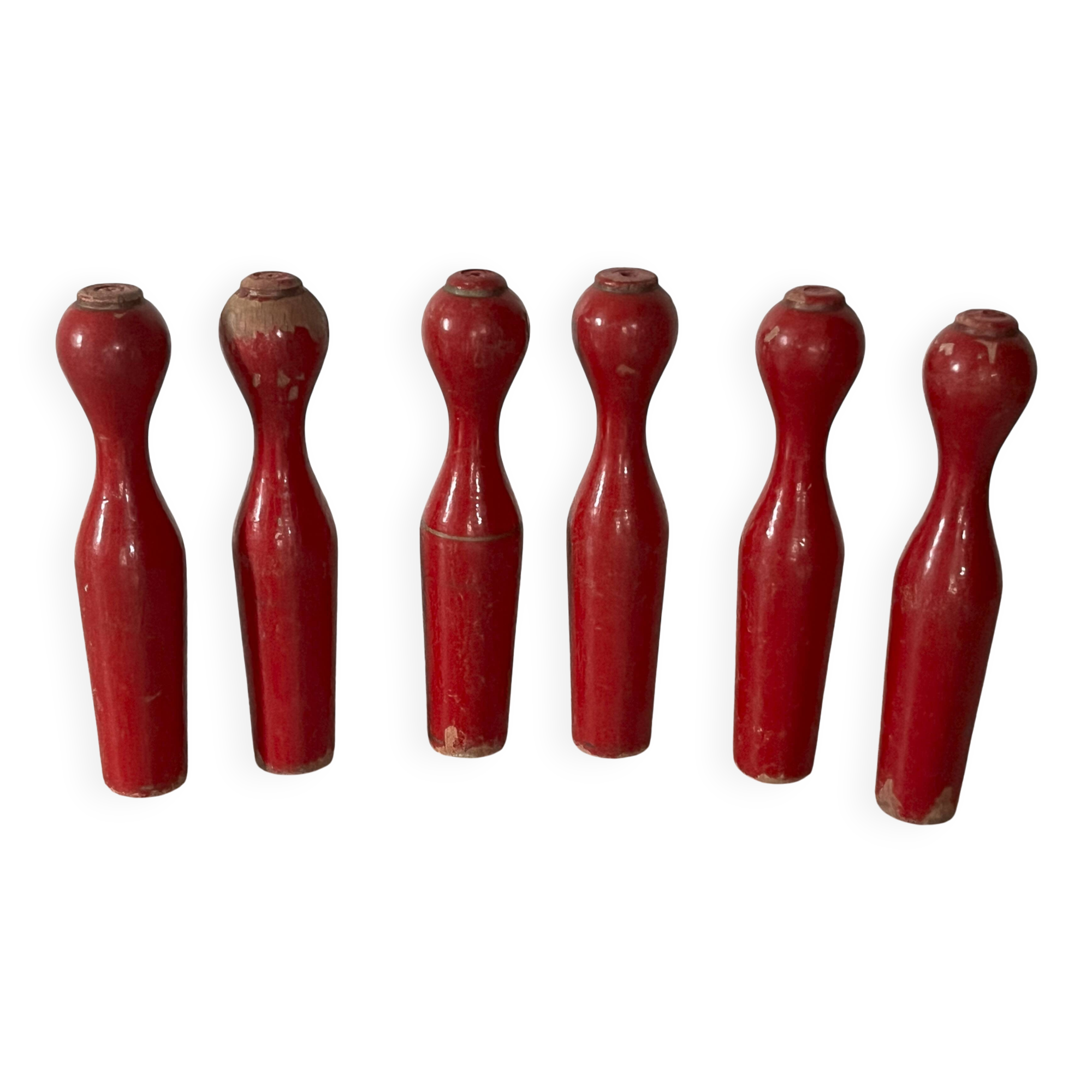 Set of old wooden bowling pins in red