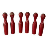 Set of old wooden bowling pins in red