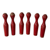 Set of old wooden bowling pins in red