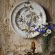 Antique Longchamp shallow dish with polychrome daisies in ironstone.