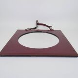 Mirror covered in burgundy leather
