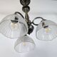 Antique Art Deco chandelier with 3 arms in patinated metal and ribbed glass.
