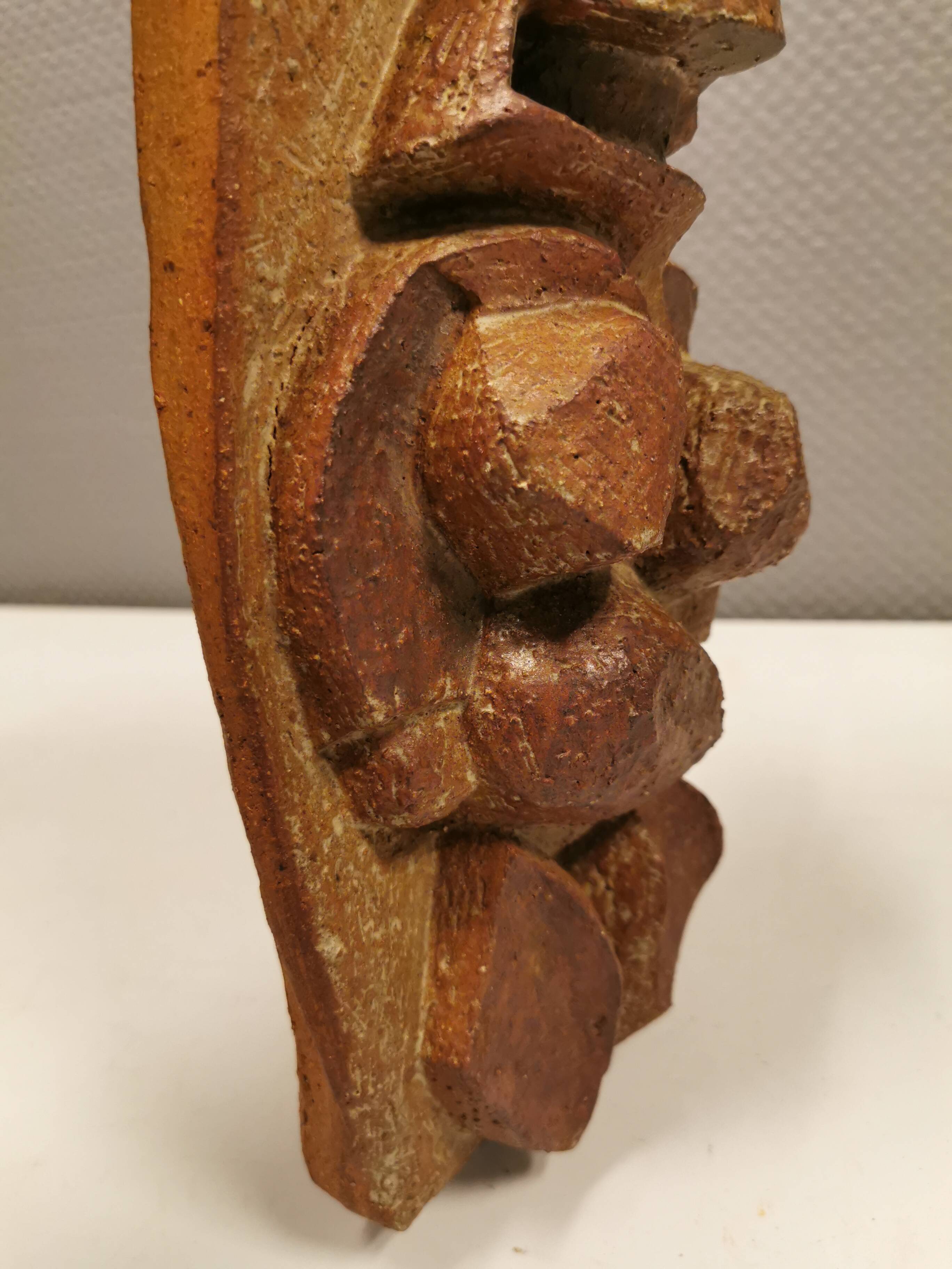 Ceramic relief portraying a lady. Emerging out of the background.