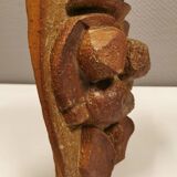 Ceramic relief portraying a lady. Emerging out of the background.