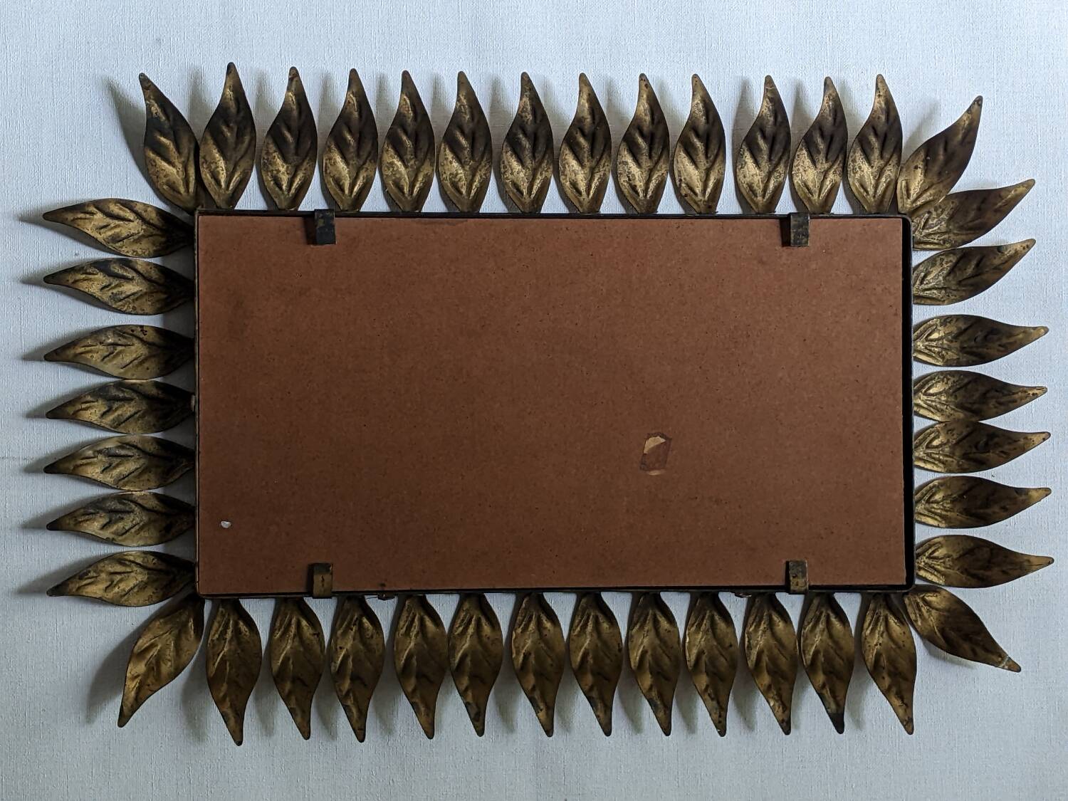Vintage gold metal mirror with leaves from the 1950s.