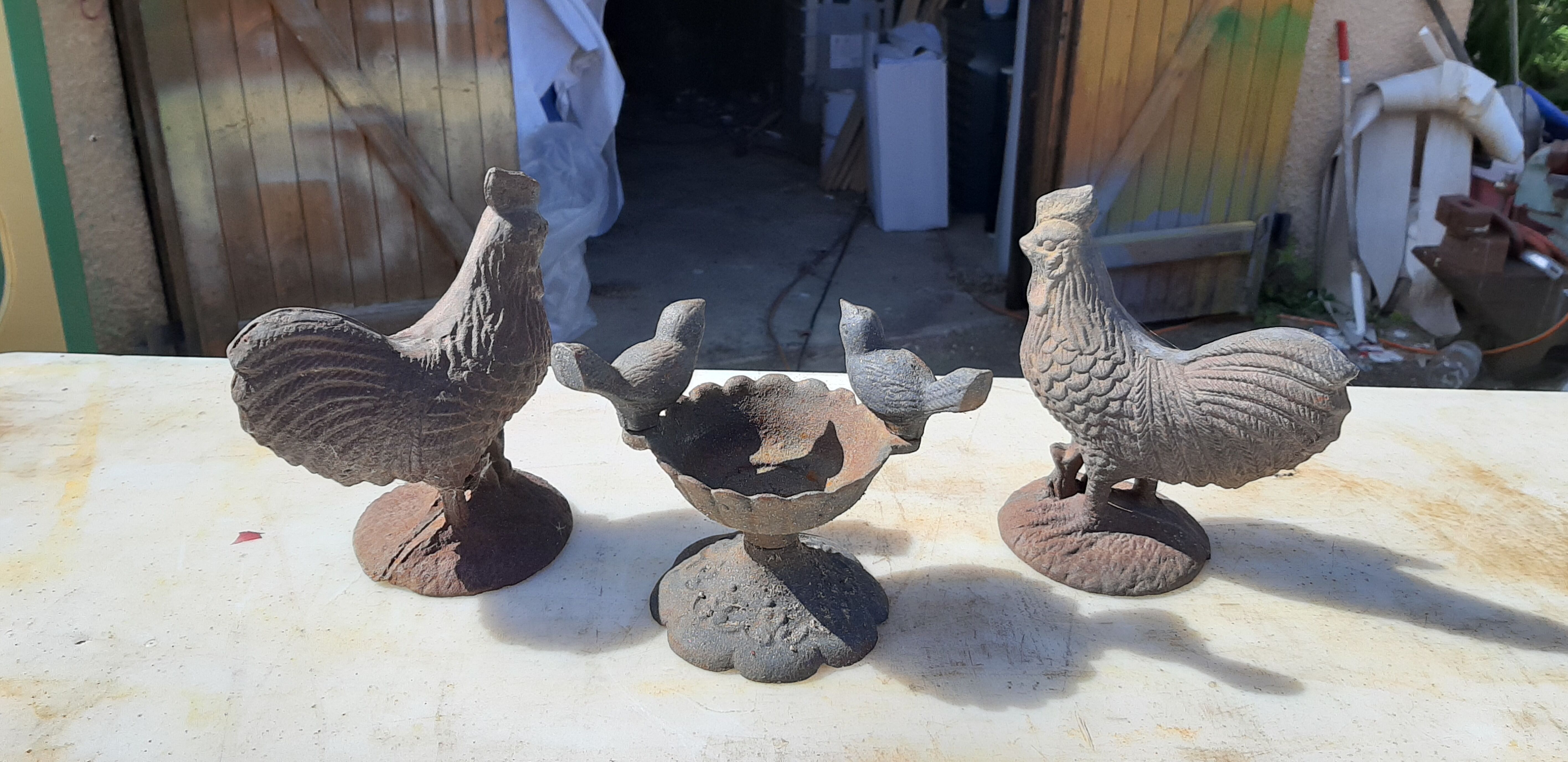2 roosters and 2 cast iron birds