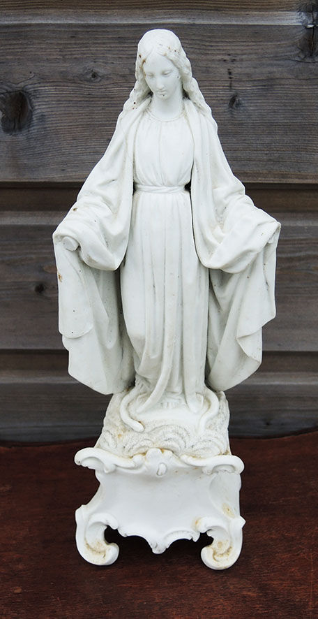 Ancient statuette of the virgin with the serpent in biscuit