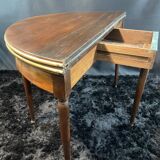 A Louis XVI period mahogany half-moon table forming a console/games table