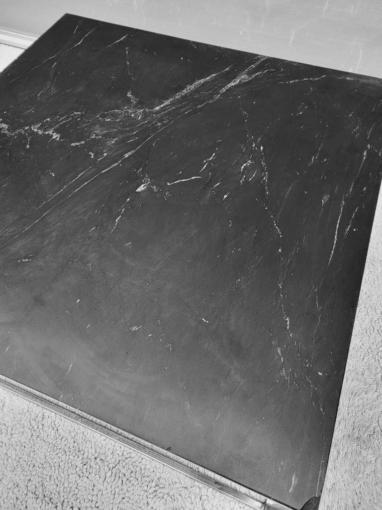 Coffee table or black marble and brass display "in its own juice"