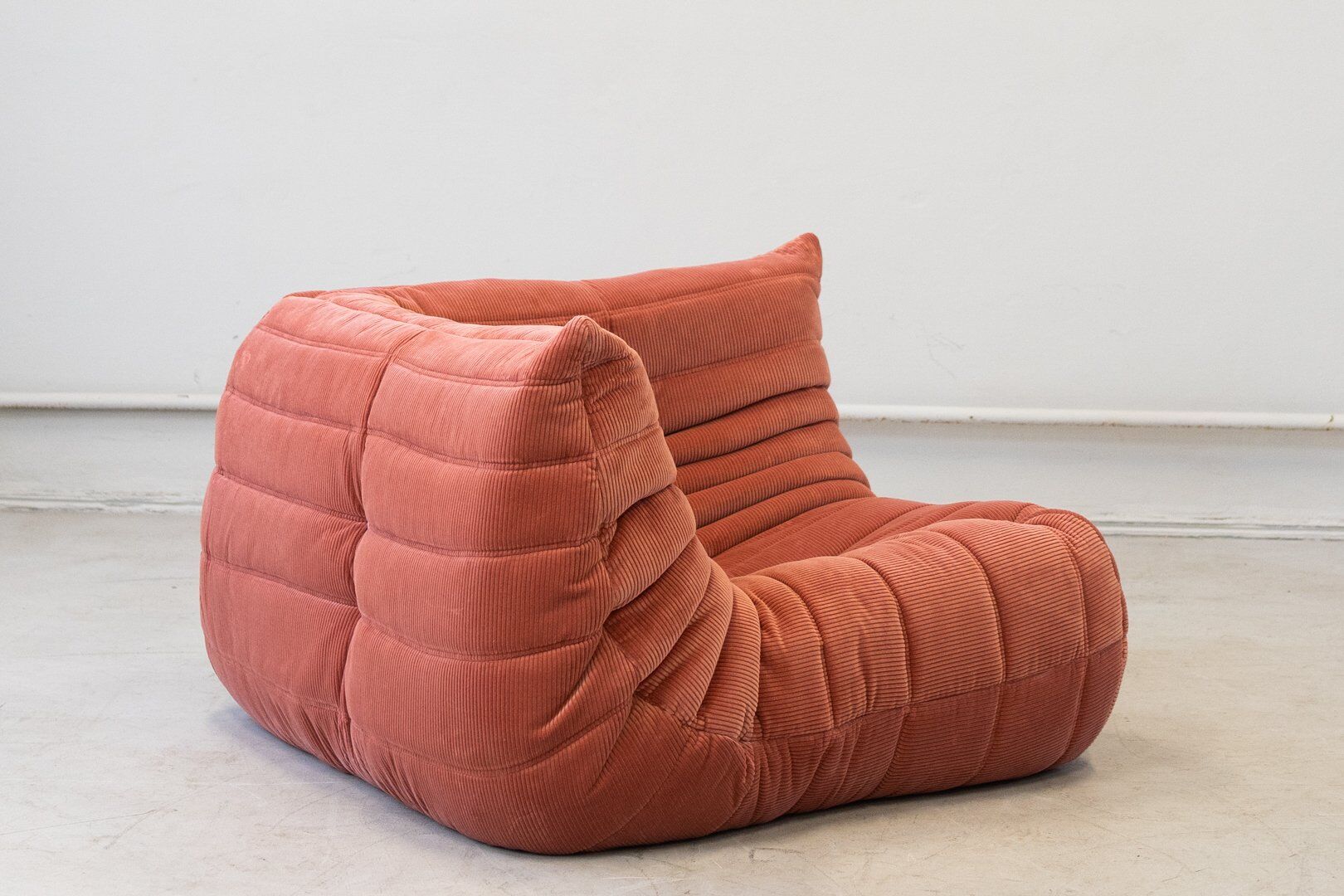 Coral corduroy Togo corner chair by Michel Ducaroy for Ligne Roset