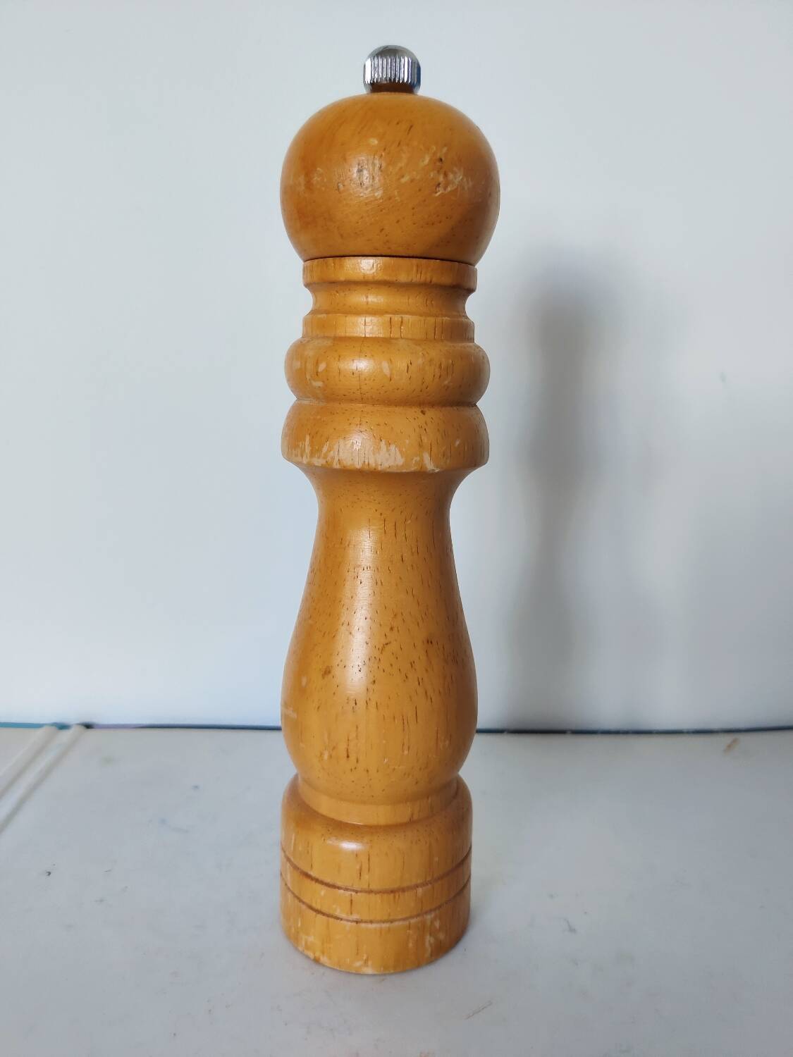 Turned wooden pepper mill