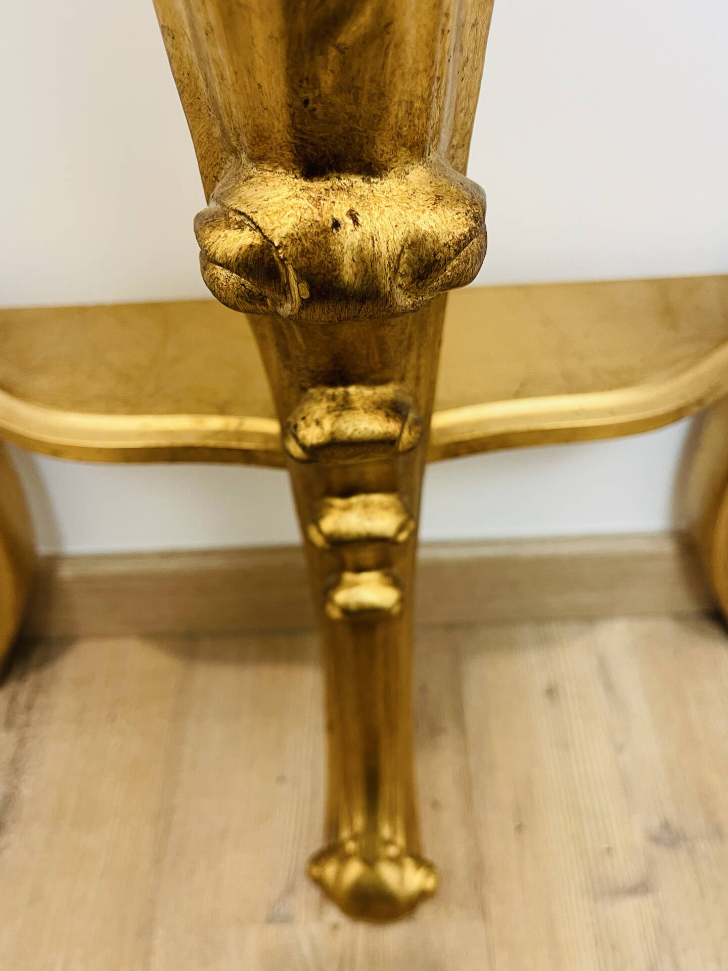 Golden console in Louis XV Rococo style made of resin.