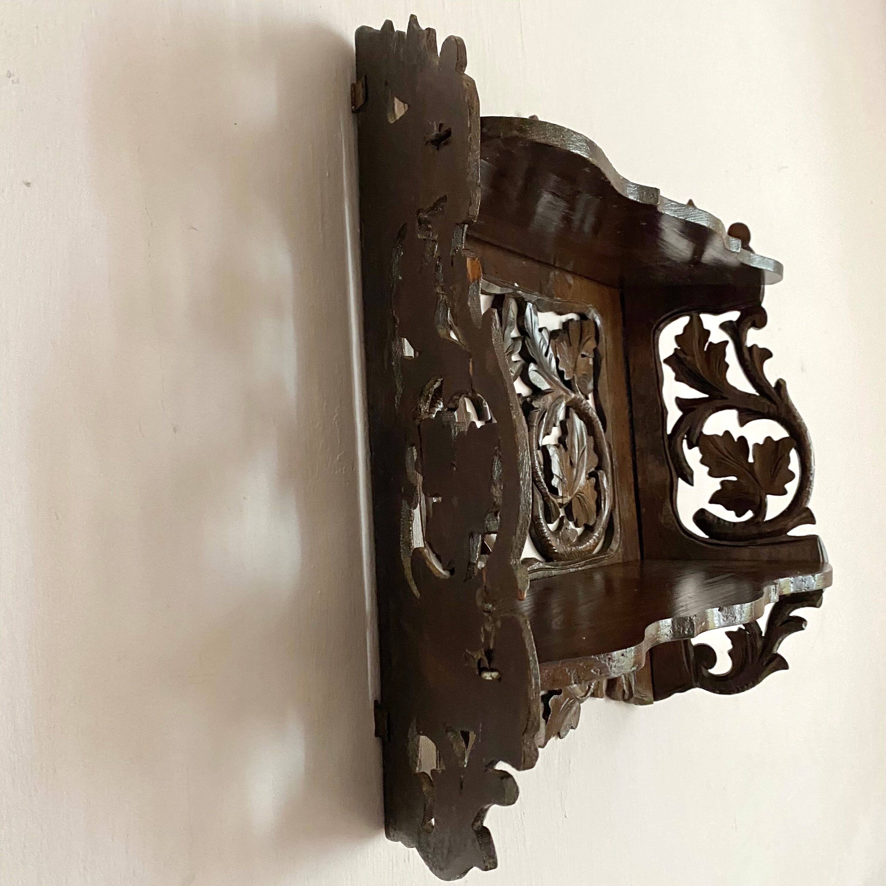 Carved wooden wall shelf