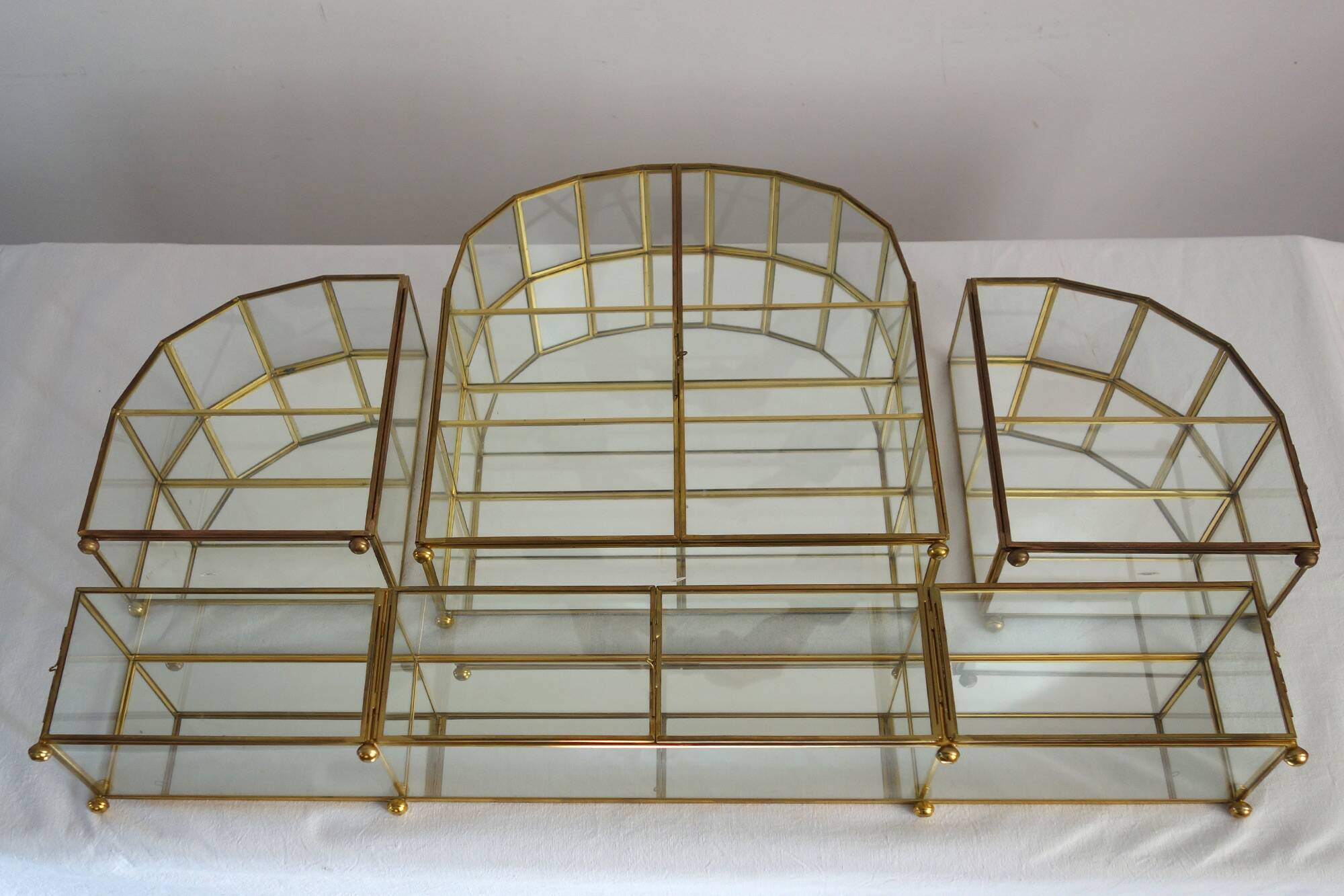 Pair of gilded brass, glass, mirror display cases from the 60s