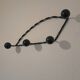 Antique design wall hook in wrought iron and painted wood.