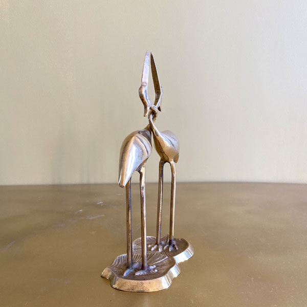 Couple of brass intertwined herons