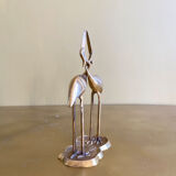Couple of brass intertwined herons
