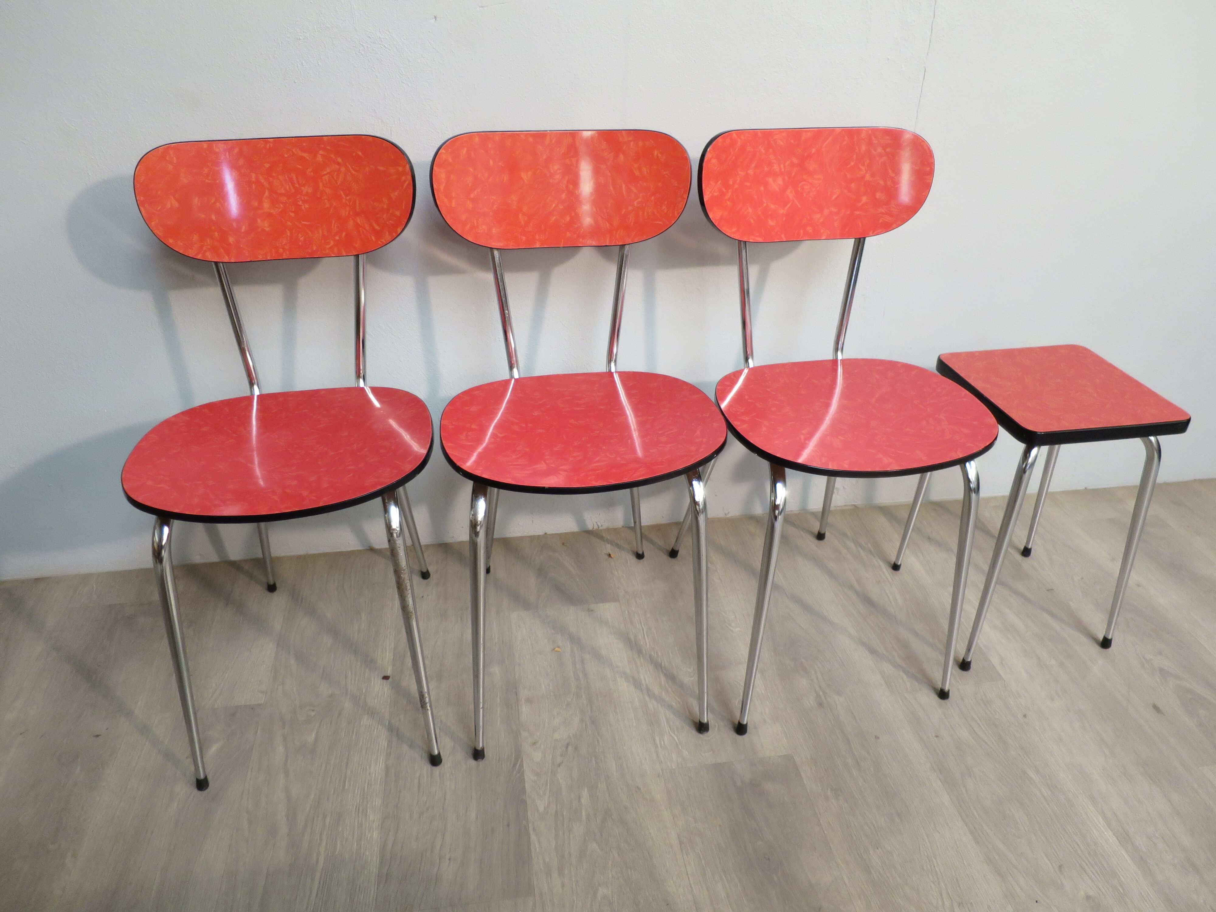 Table, 3 chairs and red formica stool
