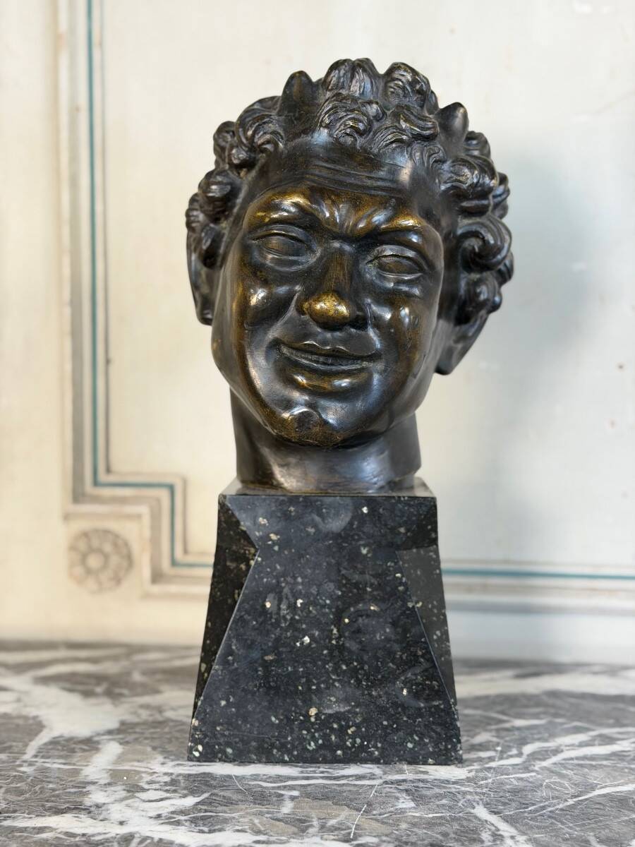 Head of a faun smiling, bronze after the antique, 19th century.