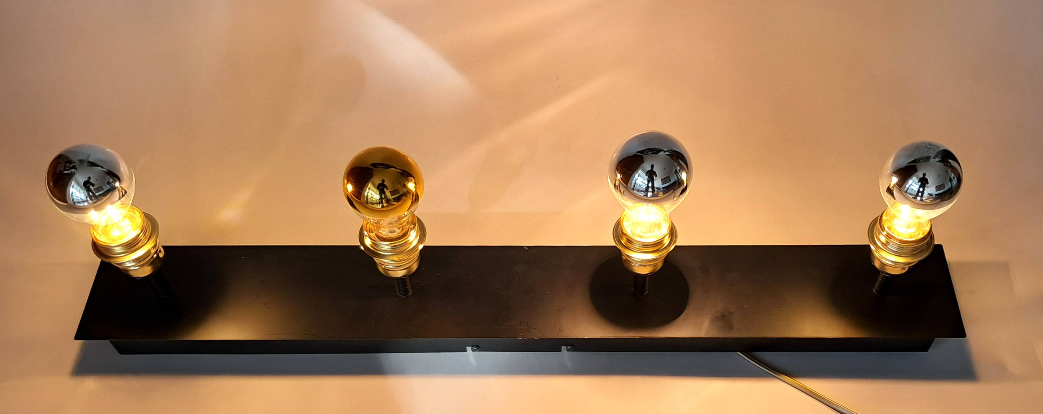 Wall lamp with 4 adjustable lights in black metal and gold-plated brass sockets.