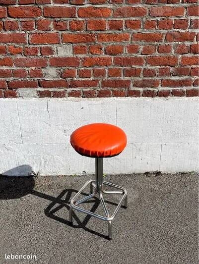 Vintage chrome stool with orange faux leather.