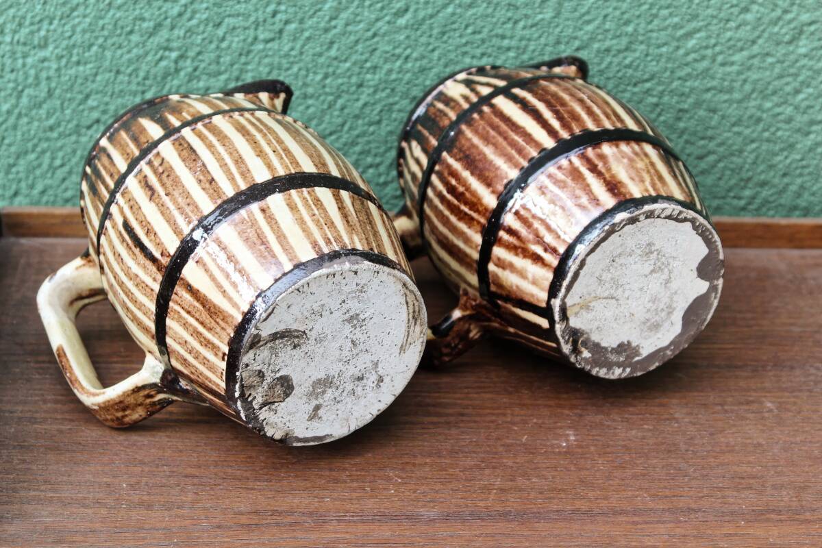 Pair of trompe l'oeil bistro pitchers, barrels