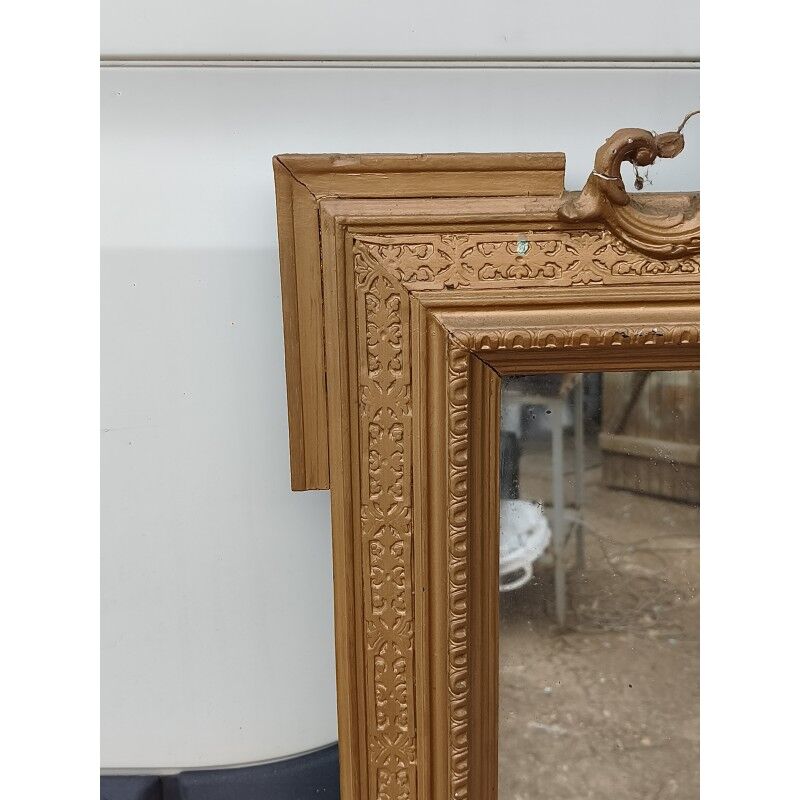 19th-century mirror in gilded wood and stucco.