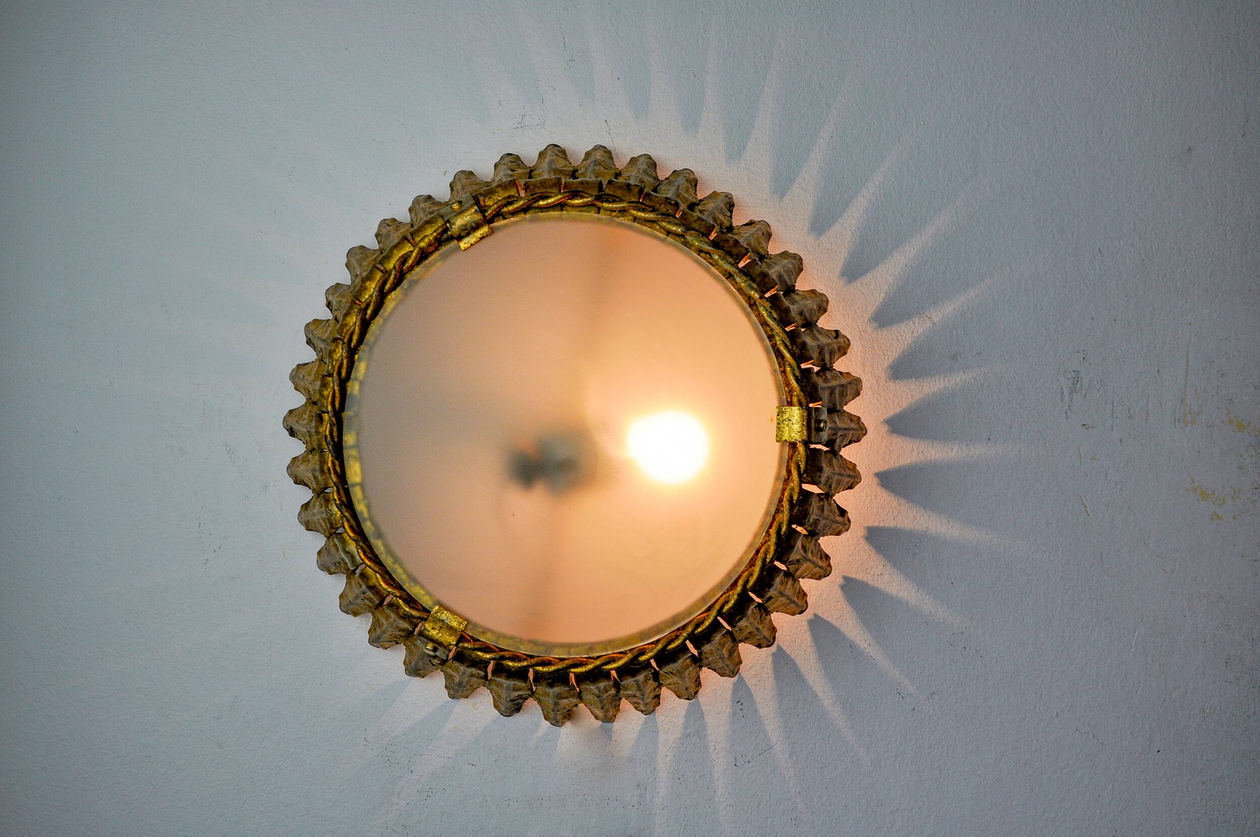 Sun wall lamp by ferro arte, metal and gold leaf, Spain, 1960