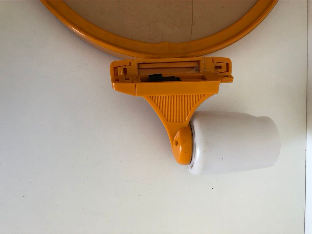 Tiltable orange plastic mirror with matching wall light
