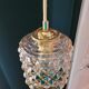 Moulded glass lamp with a cubic-spherical relief design.