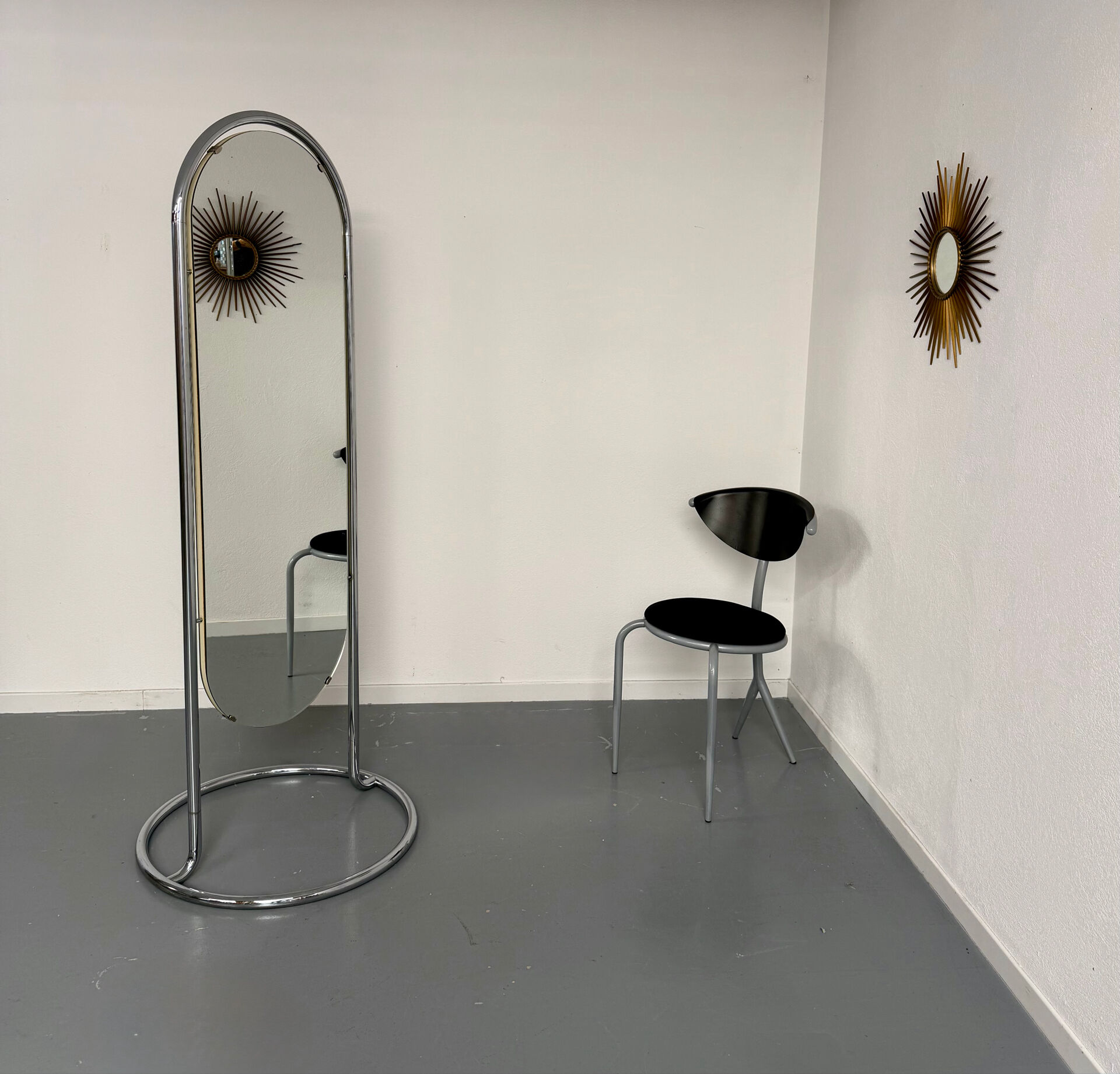 Large freestanding chrome metal full-length mirror in 1970s design.