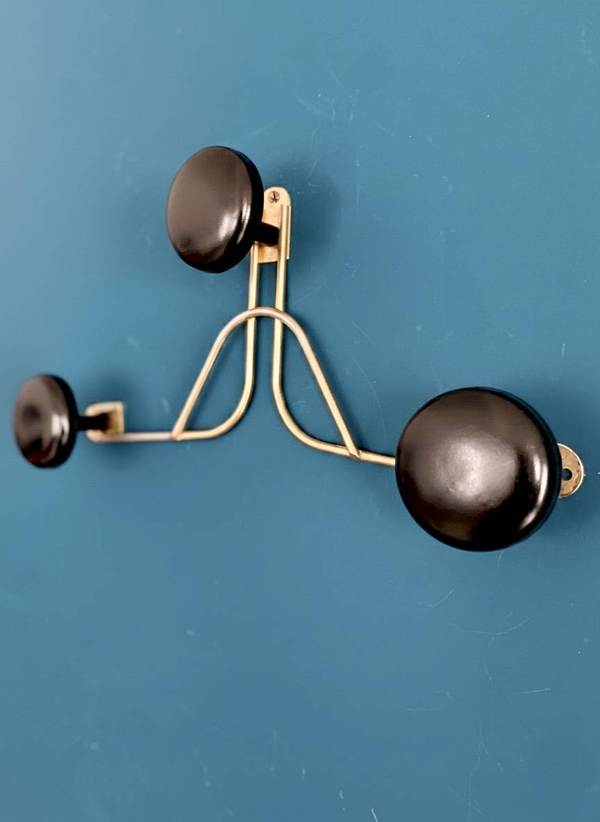 Golden brass coat rack with 3 black vintage hooks from the Mid Century 1950-60.