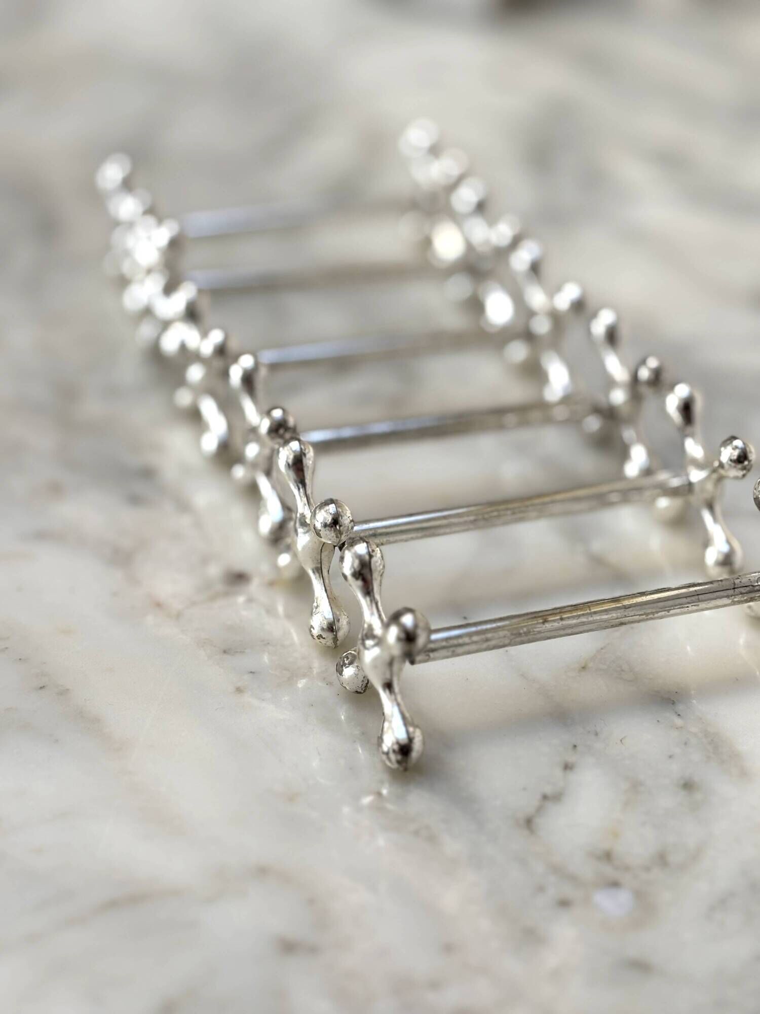 Set of 6 silver metal knife rests in the Letang Remy style