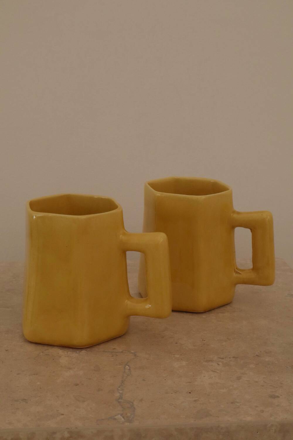 Set of two designer lemon yellow ceramic mugs
