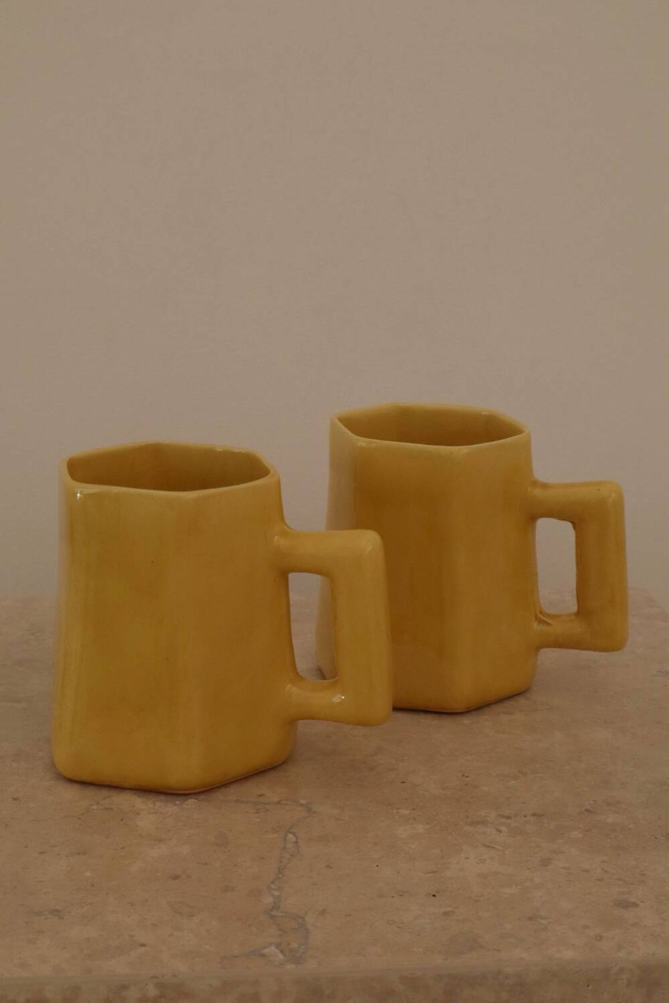 Set of two designer lemon yellow ceramic mugs