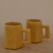 Set of two designer lemon yellow ceramic mugs