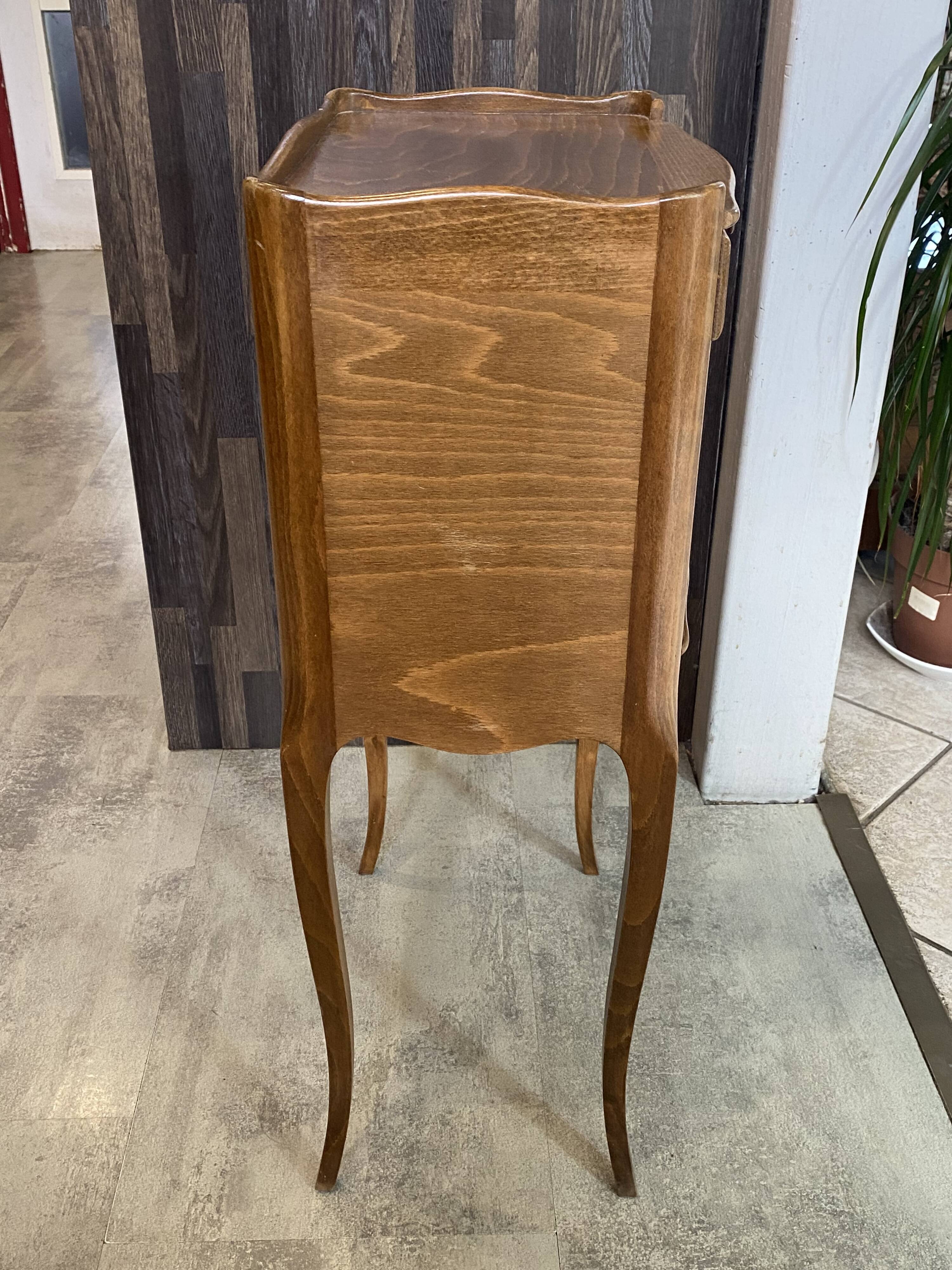 A bedside table with a drawer and a niche in Louis XV style.