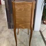 A bedside table with a drawer and a niche in Louis XV style.