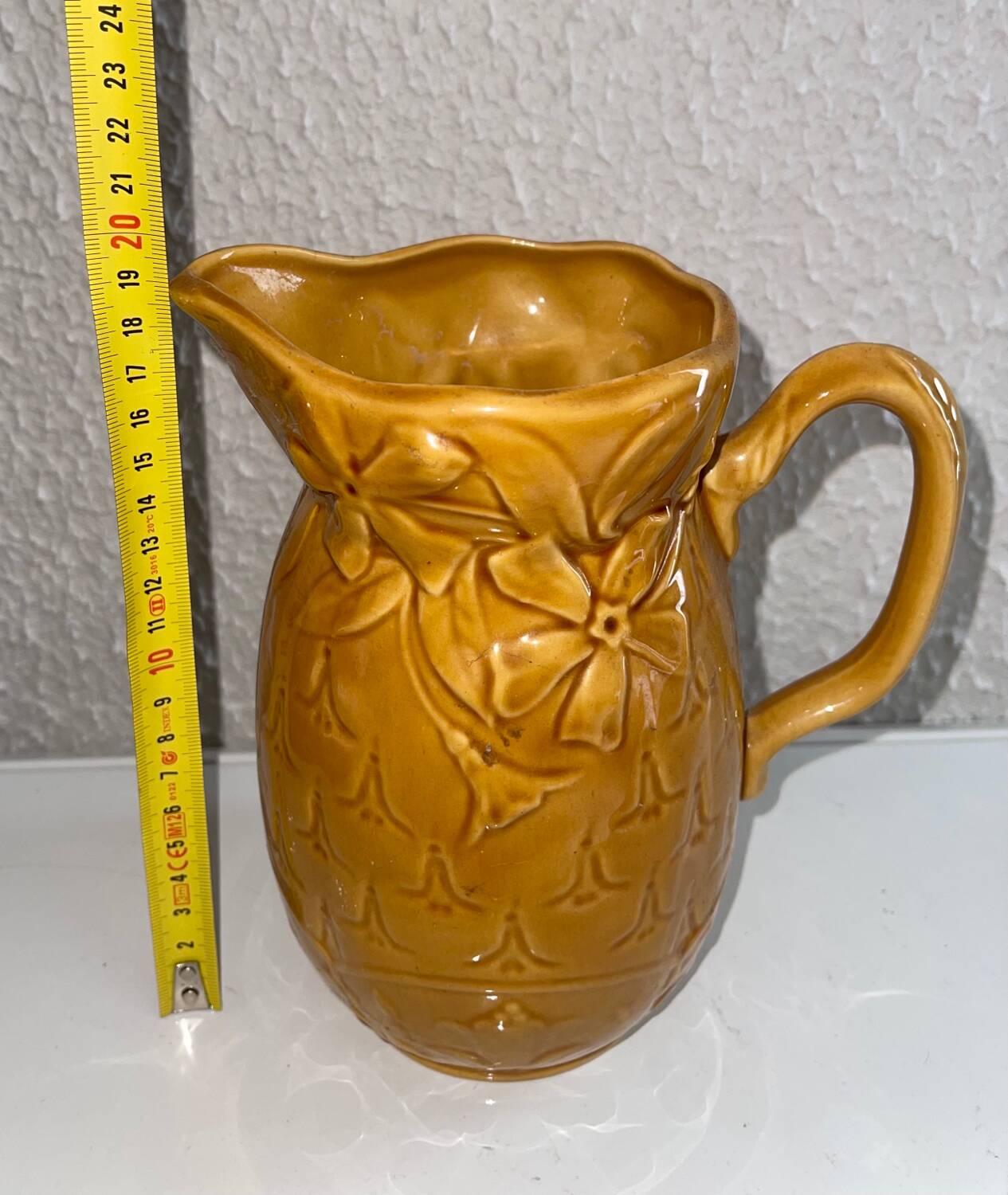 Antique pitcher with flower decoration