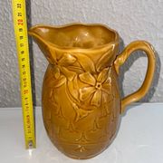 Antique pitcher with flower decoration
