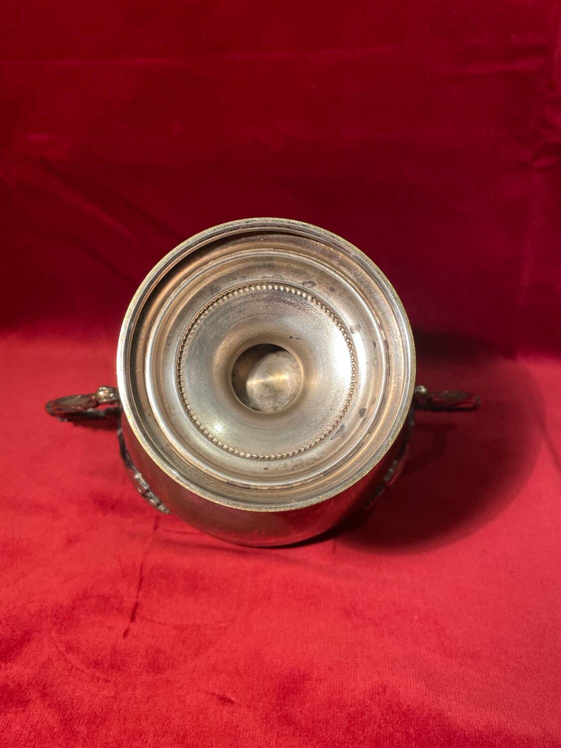 Antique sugar bowl on a stand with a lid and interior lining in velvet.