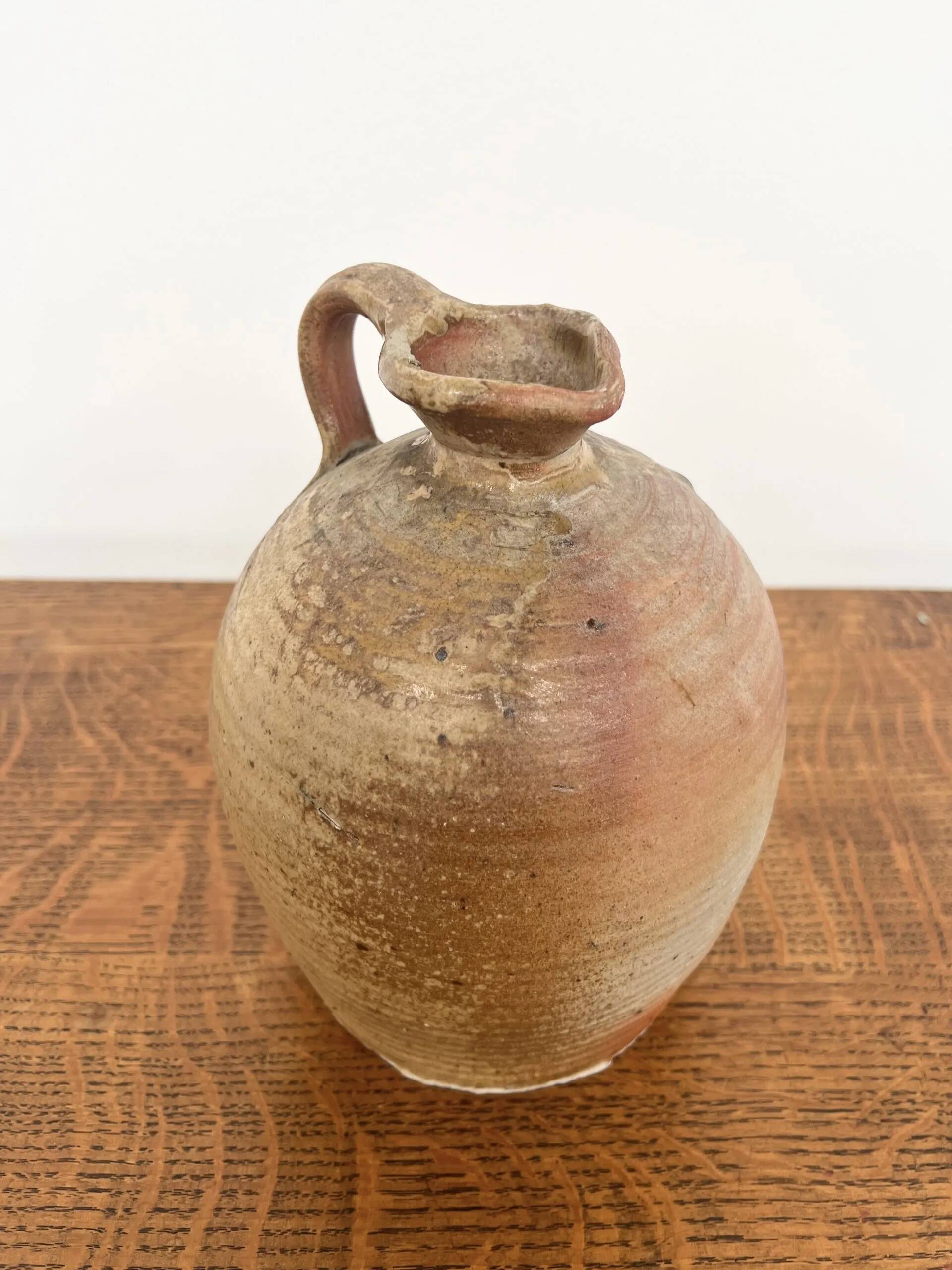 Small antique stoneware jar with handle