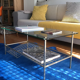 Glass coffee table with gold metal magazine holder
