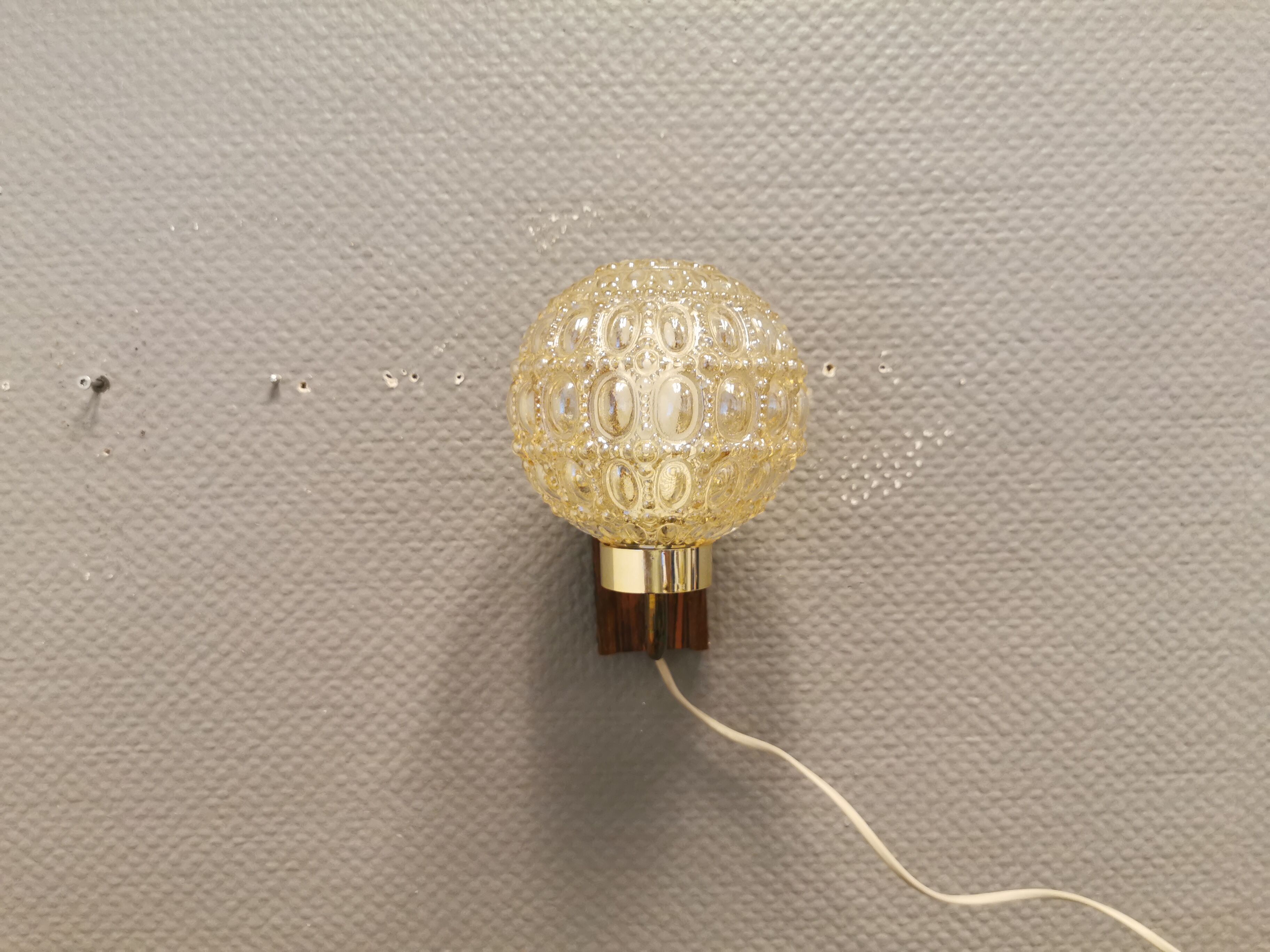 Wall light in rosewood with bobble glass ball shade.