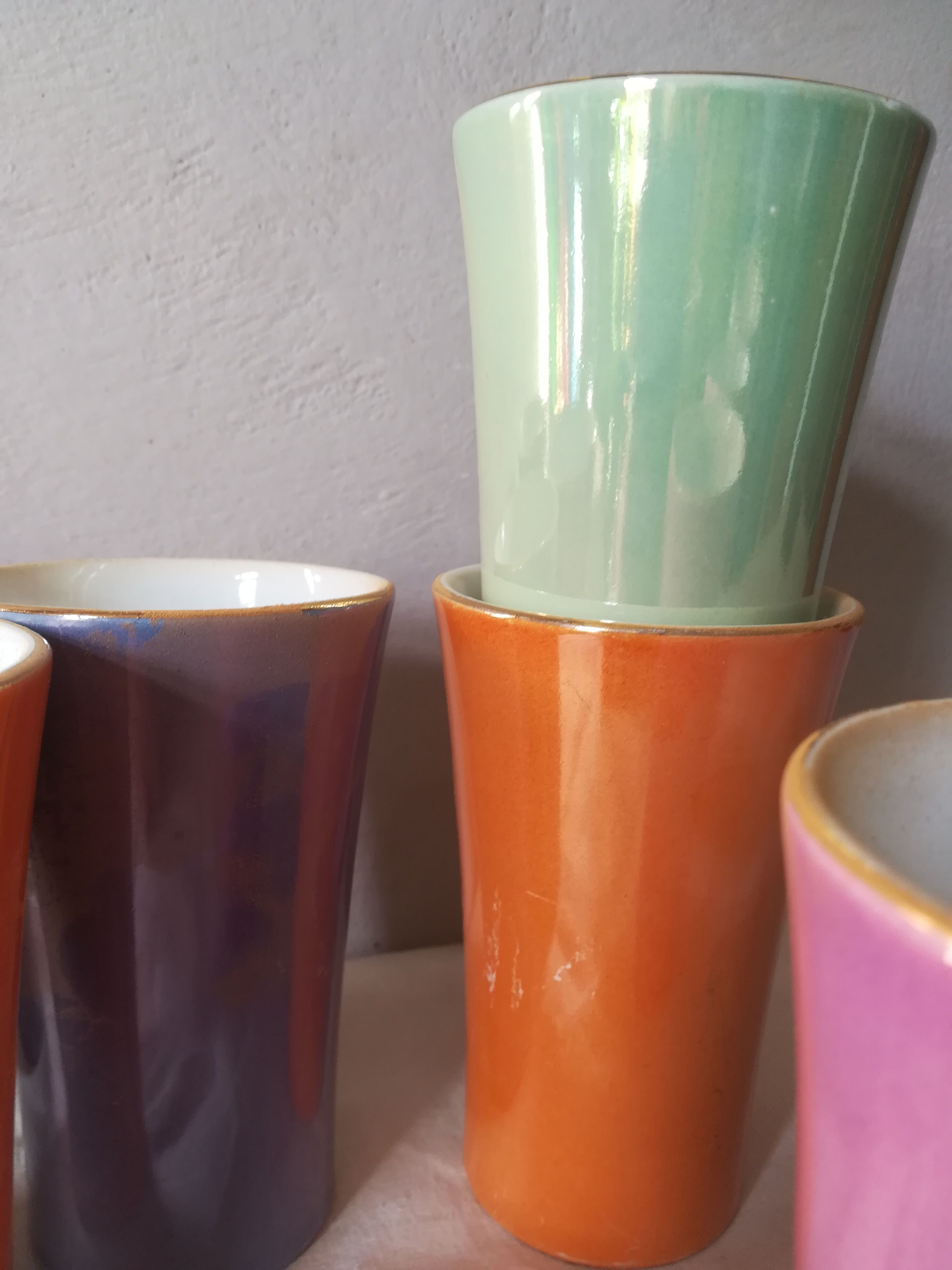 8 coloured cups in earthenware