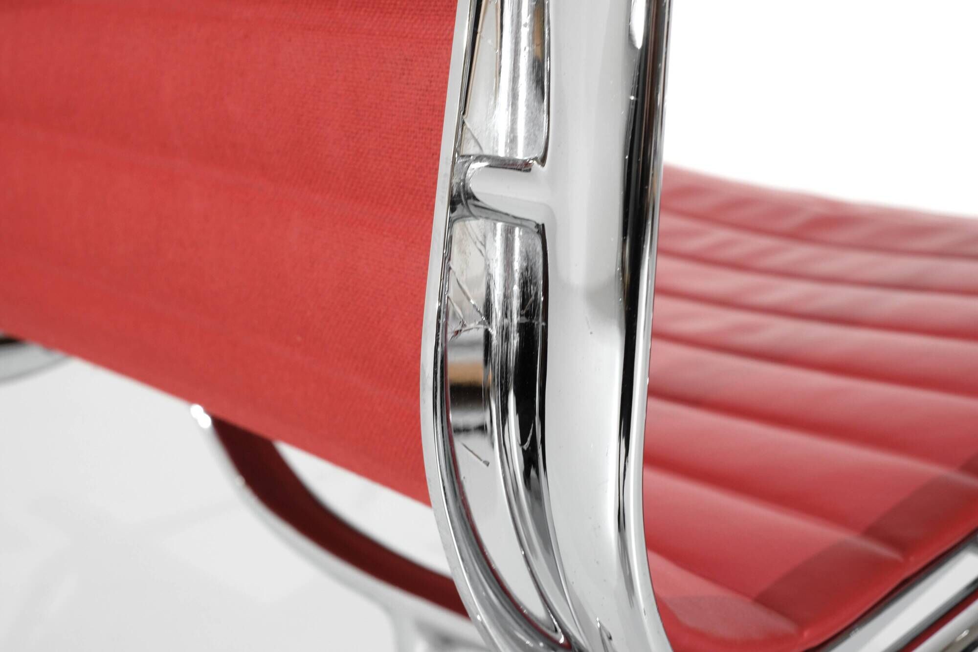 "EA 108" armchair in red leather, designed by Charles and Ray Eames for Vitra,