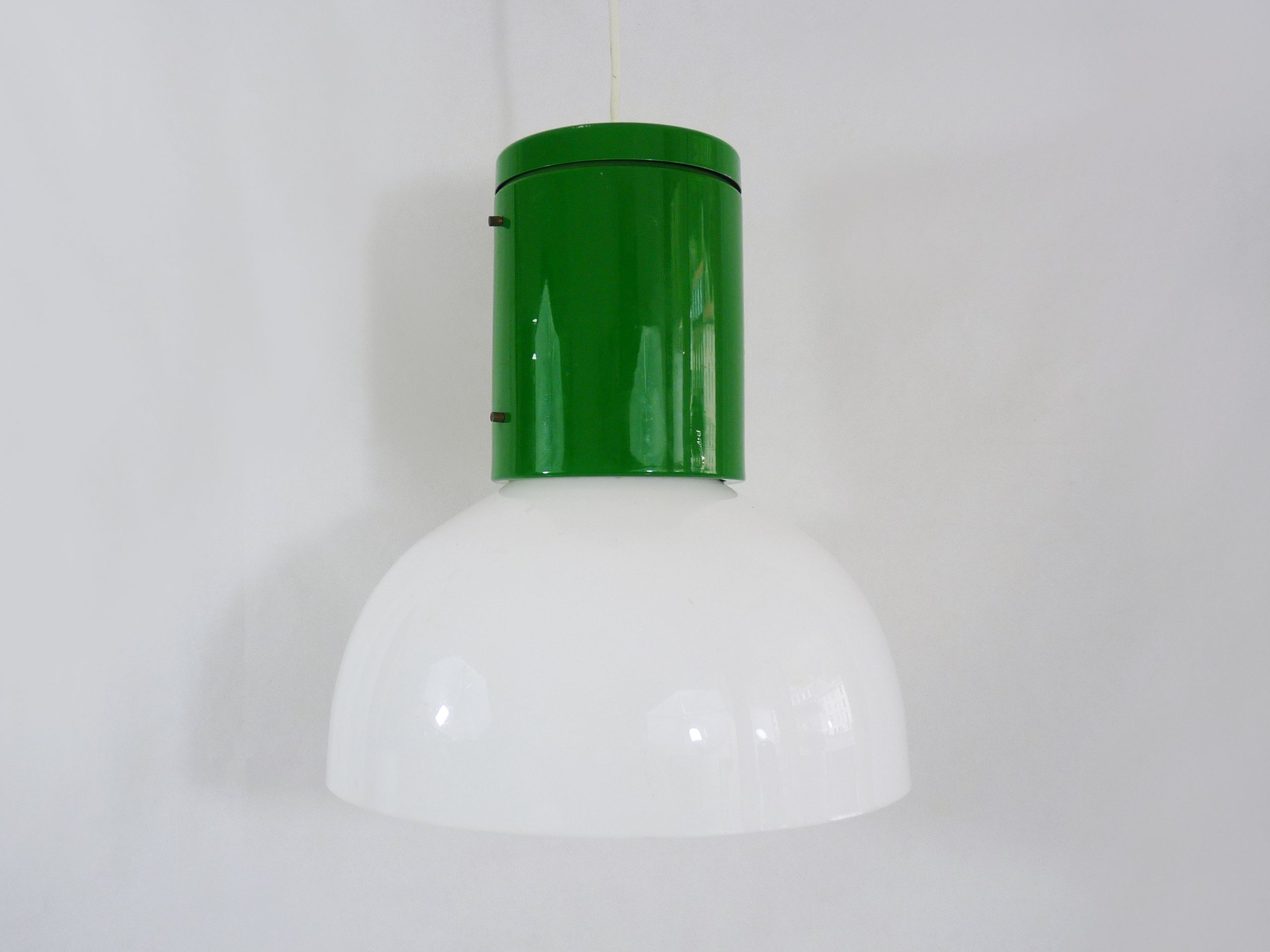 Vintage industrial suspension in green metal and white plastic lampshade. Year 70